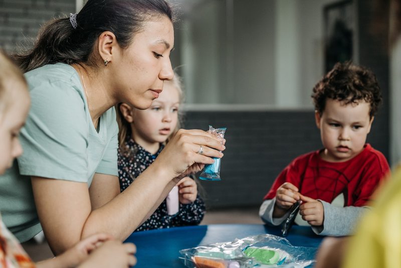 Caregiver engaging with children in a fun activity